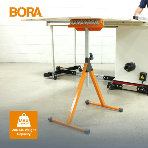 Tri Function Pedestal Roller Stand With Adjustable Height beside table saw, polished steel roller visible, in workshop