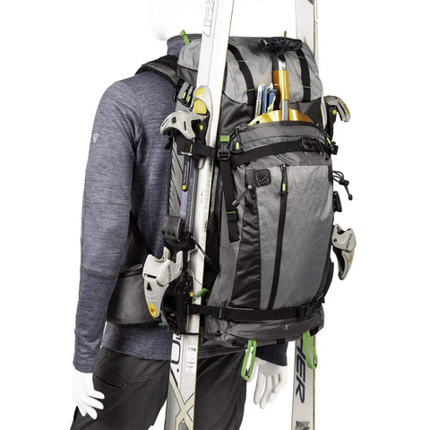 BackLight Elite 45L Camera Daypack For DSLR And Mirrorless Gear, Photo And Video Ready, Rugged Grey, side view with ski gear