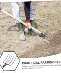 Person using Handheld Pitch Fork For Manure And Straw Cleanup, Lightweight Farm Fork on soil, showing fork's practical application.