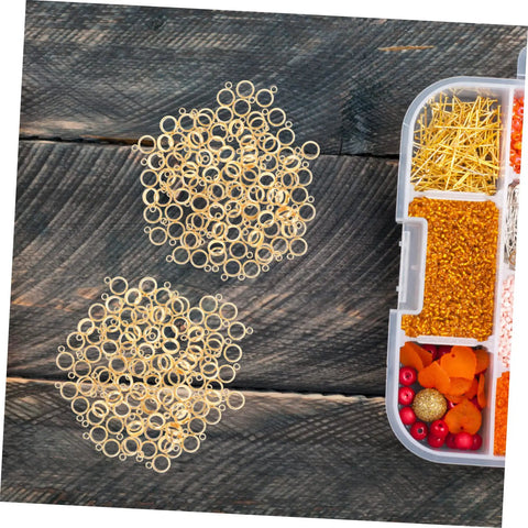 Top Shelf Go To Diy Jewelry Making Kit Featuring Stainless Steel Bail Bead Jump Rings And Polished Chrome Spacer Links For Custom Necklaces Bracelets And Artisan Creations, gold jump rings on wood.
