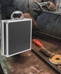 Boss Grade Aluminum Alloy Toolbox Featuring Secure Locking Panel And Portable Tool Stash Hella Tough against a rustic workbench.