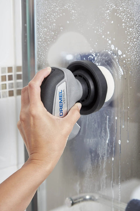 Person using 16 Piece Versa Power Scrubber Accessory Value Kit with 15 cleaning pads for cleaning shower glass