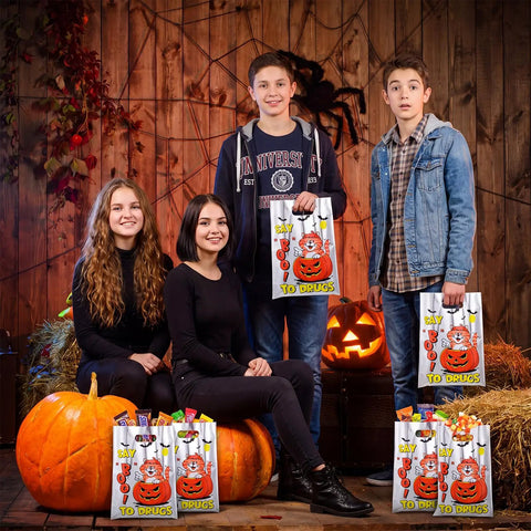 Teens holding Say Boo To Drugs Halloween Reflective Gift Bags 150 Pack for Trick Or Treat Parties Party Favors and decorations.