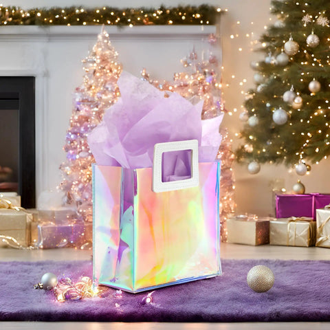 Holographic Gift Bags With Handles And Tissue Paper Sheets Included, Iridescent Transparent Reusable Purple Gift Bags, 8 By 7 By 4 Inch, shown by Christmas tree.
