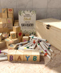 Baby Shower Games Sign Kit With 60 Wooden Blocks And 36 Colored Markers, Includes A Wooden Storage Box, Perfect For Decor, Guest Activities, And Fun Gift Ideas., wooden blocks and markers beside sign and box