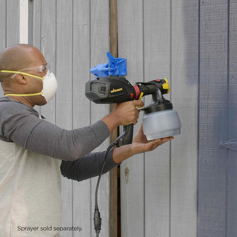 Person using iSpray Front End Nozzle For HVLP Sprayers Broad Interior And Exterior Coverage spraying a wooden wall