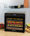 Top Shelf Eight Tray Stainless Steel Food Dehydrator Running Smooth With Digital Timer And Adjustable Temp Control Made For Killer Jerky Dried Fruits Veggies Fresh Herbs Dog Biscuits 650W Bpa Free showcasing sliced fruits on trays.
