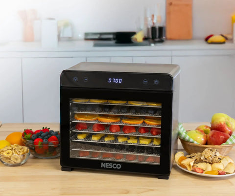 Top Shelf Eight Tray Stainless Steel Food Dehydrator Running Smooth With Digital Timer And Adjustable Temp Control Made For Killer Jerky Dried Fruits Veggies Fresh Herbs Dog Biscuits 650W Bpa Free showcasing sliced fruits on trays.