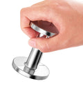 Hand holding Pro Grade 2 Inch Espresso Tamper For Baristas Durable Stainless Steel Build Delivers Even Heat For Consistent Temperature.