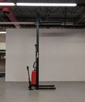 Heavy Duty Thin Leg Semi Electric Pallet Stacker 2204 Lbs Capacity 138 Inch Lift Height 110V Plug displayed in warehouse.