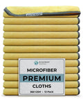 Stack of Premium Microfiber Cleaning Towels 16x16 12 Pack Yellow Reusable, folded with label visible, showcasing dense warp-knit fabric.