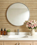 Super Slick Peel And Stick Grasscloth Wallpaper With Dead Simple Self Adhesive Backing For Modern Accent Walls And Apartment Rentals In Earthy Beige Tan Hues in bathroom setting with mirror and flowers.