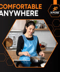 Person cooking wearing blue disposable aprons bulk pack of 1000 count 24x48 inches waterproof polyethylene, individually wrapped, heavy duty.