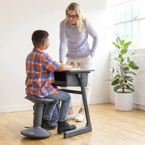 Child using SitWell Wobble Stool With Adjustable Height For Active Seating In Classrooms And Libraries, Promotes Core Strength.
