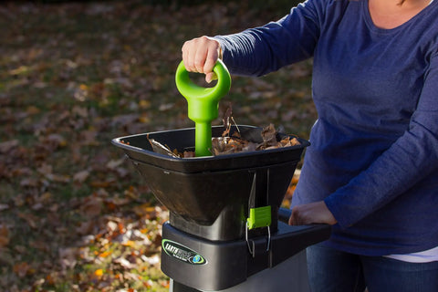 15 Amp Corded Electric Garden Chipper With Collection Bin For Branches Up To 1.8 Inches Power Through Sticks And Brush For Easy Yard Cleanup No Gas Or Fumes being used in a garden