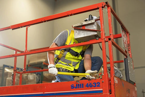 Worker using adjustable non-shock absorbing lanyard 4 to 6 feet yellow for fall protection at height on lift platform