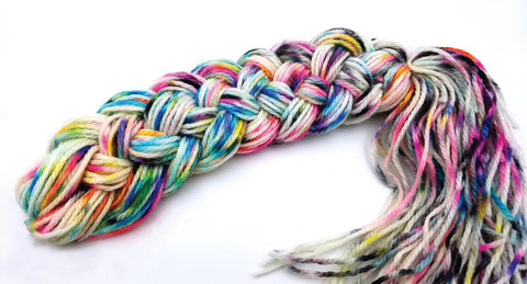 Multicolored yarn skein twisted into a thick braid; rainbow pastel hues.