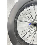 Close-up of 700c Carbon Road Bike Wheelset with Deep Section 60 65mm Aero Rims Matte Black Lightweight Spokes for Beast Mode Speed Reduced Drag