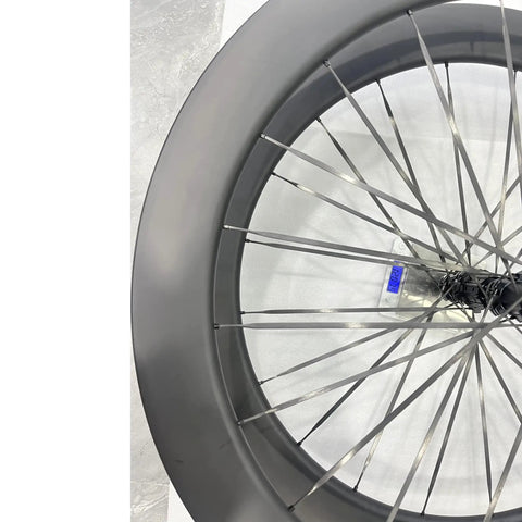 Close-up of 700c Carbon Road Bike Wheelset with Deep Section 60 65mm Aero Rims Matte Black Lightweight Spokes for Beast Mode Speed Reduced Drag