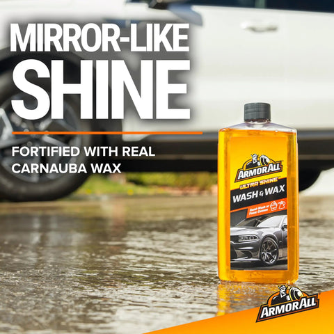 All In One Car Cleaning Kit With Wash And Wax Glass Wipes Tire Foam And Protectant Four Piece Auto Detailing Set bottle on wet surface