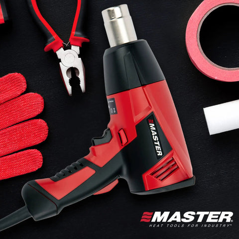 Beefy Heavy Duty Industrial Electric Heat Gun With Quick Change Element centered on workbench with tools and tape