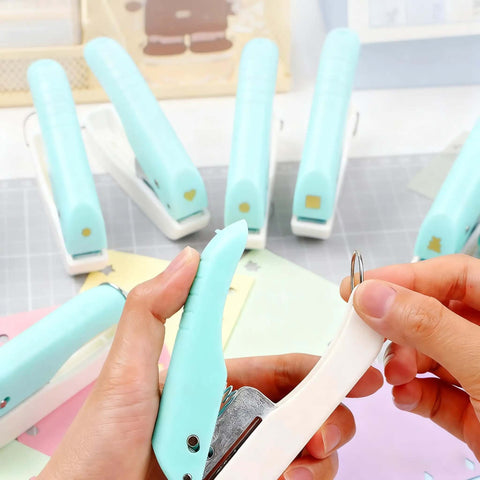 Person using One-Handed 2mm Circle Pattern Embosser With Built-In Waste Storage, Easy-Squeeze Punch Tool in sky blue on paper crafts.