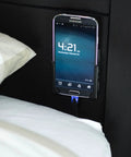 Legit Sturdy Black Smartphone Mount With Heavy Duty Screw Or Tape Options For Vehicles And Home Desk No Sweat Setup And Broad Compatibility mounted beside bed.