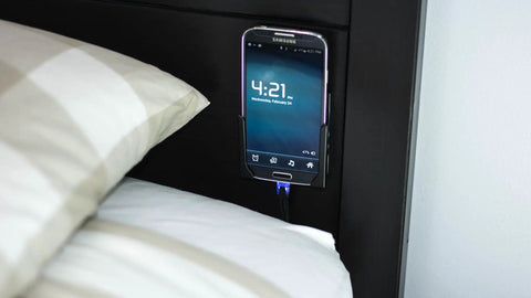 Legit Sturdy Black Smartphone Mount With Heavy Duty Screw Or Tape Options For Vehicles And Home Desk No Sweat Setup And Broad Compatibility mounted beside bed.