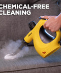 Heavy Duty Handheld Steam Cleaner Badass Chemical Free Deep Powerhouse With 11 Slick Nozzles For Kickin Grime Off Floors Carpets And Kid Safe Home Sanitizing Tools in use on a couch.