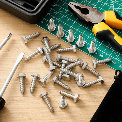 50 Pack 1/4 In By 1 In Hex Head Lag Screws 304 Stainless Steel Heavy Duty Wood Bolts scattered on a workbench with tools