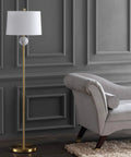 60 Inch Dope Brass Gold And White Modern Floor Lamp With White Linen Drum Shade beside a gray sofa, featuring foot switch, UL listed