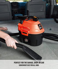 Compact 2.5 Gallon Wet Dry Shop Vacuum With 2 Peak HP Blower Function in use on car seat with crevice tool and hose