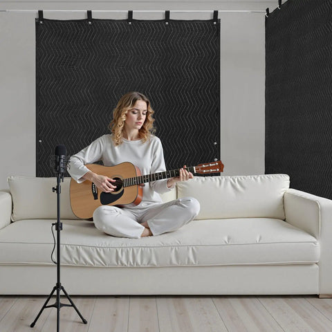 Woman playing guitar in room with black Sound Dampening Blanket With Grommets For Windows And Doors, 80 by 48 Inch Sound Blocker Curtain