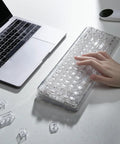 Compact Wireless Mechanical Keyboard Featuring Hot Swap Switches And Clear Caps For Streamlined Desk Setup Custom Backlight And Gasket Mount, shown with a hand typing.