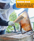 Beekeeper using Beekeeping Brush With Natural Horsehair And Wooden Handle For Hive Cleaning during honey harvest