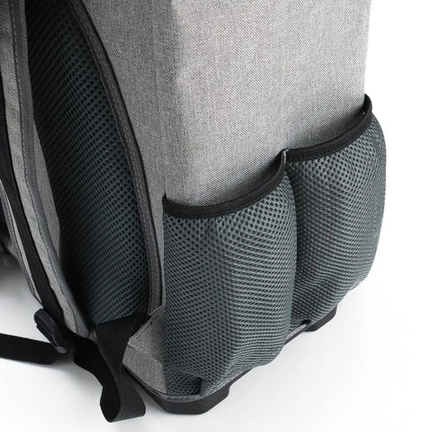 Side view of heavy-duty tool backpack with laptop compartment, waterproof molded base, and padded back support.
