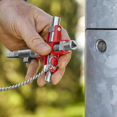 Hand holding Universal Construction Control Cabinet Key with Plug In Magnetic Support for Profile Cylinder Locks