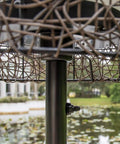 Close-up of Tanglewood Outdoor Floor Lamp in oil rubbed bronze with a frosted bulb shield, reflecting elegant outdoor design.