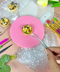 Premium Top Shelf 67 Piece Cookie Decorating Kit With Smooth Turntable Pro Brushes Scribe Needles Non Slip Pads Fresh Piping Bags For Totally Sick Cake Artists on pink turntable, cookie decorated with toppings.