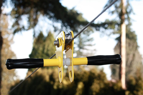 Close-up of stainless steel trolley with dual ball bearings on 50 ft galvanized cable for Backyard Zip Line Kit With 50 Foot Galvanized Cable, Sturdy Stainless Steel Trolley With Dual Ball Bearings, Easy Setup For Safe Family Fun And The Whole Crew Outdoors, Durable Cable System For Home Play From Deck Or Tree.