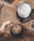 4 In 1 Milk Frother And Steamer 500ml Stainless Steel Electric Foam Maker With Hot Thick Foam Hot Thin Foam Hot Milk Or Cold Foam Barista Grade At Home For Lattes And Cappuccinos Easy Dial Controls And LED Indicators on wooden table