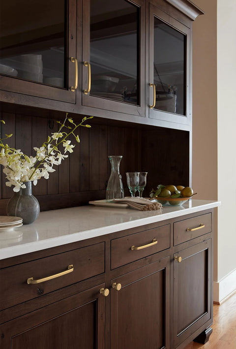 Champagne Bronze Surpass Cabinet Pull Five And One Sixteenth Inch Center To Center on dark wood kitchen cabinets