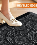 Ergonomic 0.47-Inch Thick Kitchen Mat With Non Slip Waterproof Standing Pad For Home Or Office Comfortable Foam Cushion Large 17.3 By 28 Inch Rug Great For Kitchen Laundry Black with a person's foot stepping on it, showing beveled edges.