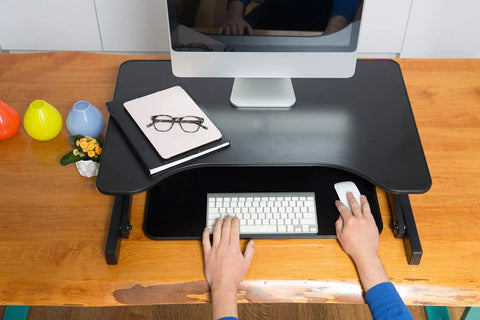 32 Inch Height Adjustable Standing Desk Converter With Slide Out Keyboard Tray and Dual Monitor Riser in use with computer setup