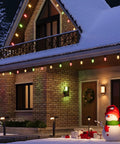 House with Lit Smart Outdoor Spotlight Kit 4 Pack 12V Low Voltage Landscape Lights illuminating snowy garden and festive decor