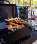 Cooking meats and vegetables on a Table Top Wood Pellet Grill With Flame Broiler For Direct Searing Up To 1000°F, 7 Lb Hopper