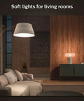 White Smart Light Starter Kit With Bridge And Two 75W A19 E26 LED Soft White Bulbs illuminating a modern living room scene