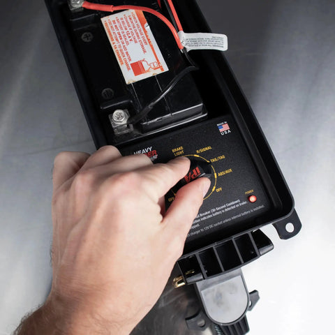 Hand operating Portable Trailer Light Tester With 7 Way Round Pin SAE J560, showing battery compartment and connectors.