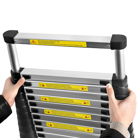 12.5ft Telescoping Aluminum Ladder With Locking Mechanism Extendable And Collapsible For Attic And Home Or Outdoor Use Heavy Duty 330 Lb Capacity Easy To Store And Setup Built For Pro Grade DIY, folded aluminum ladder with hands closing it