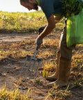 Gardener using All Purpose Garden Fork Four Tine Workhorse For Soil Breaking And Manure Handling in field